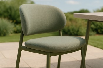 Close-up of an outdoor dining chair with a soft curved backrest