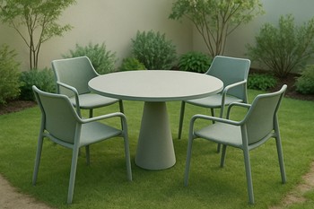 Round outdoor dining table with four chairs on a small lawn