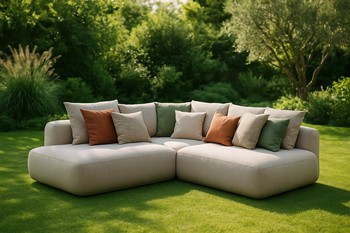 Wide outdoor lounge island with mixed cushions on a central lawn