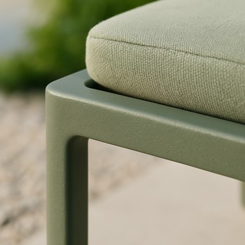 Close-up of a rounded outdoor frame corner above deep green lawn