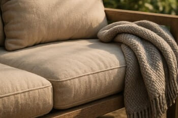 Close-up of deep outdoor seat cushion with soft edge above grass