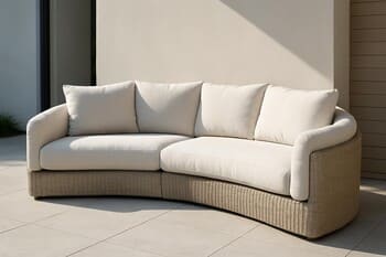 Tall outdoor lounge chair with curved back on a deep green lawn