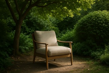 Single lounge chair placed in deep shade beside a tree trunk